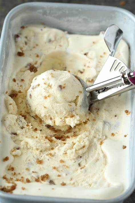 Butter Scotch Ice cream placed in a scoop and a container.