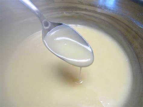 Add the milk and vanilla extract to the sugar mixture, whisking until smooth