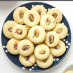 "Milk Peda Recipe!!" and "queenofrecipes.online" written on an image with Milk Peda.