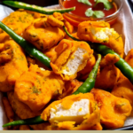 " Paneer PakoraRecipe!!" and "queenofrecipes.online" are written on an image with a Paneer Pakora.